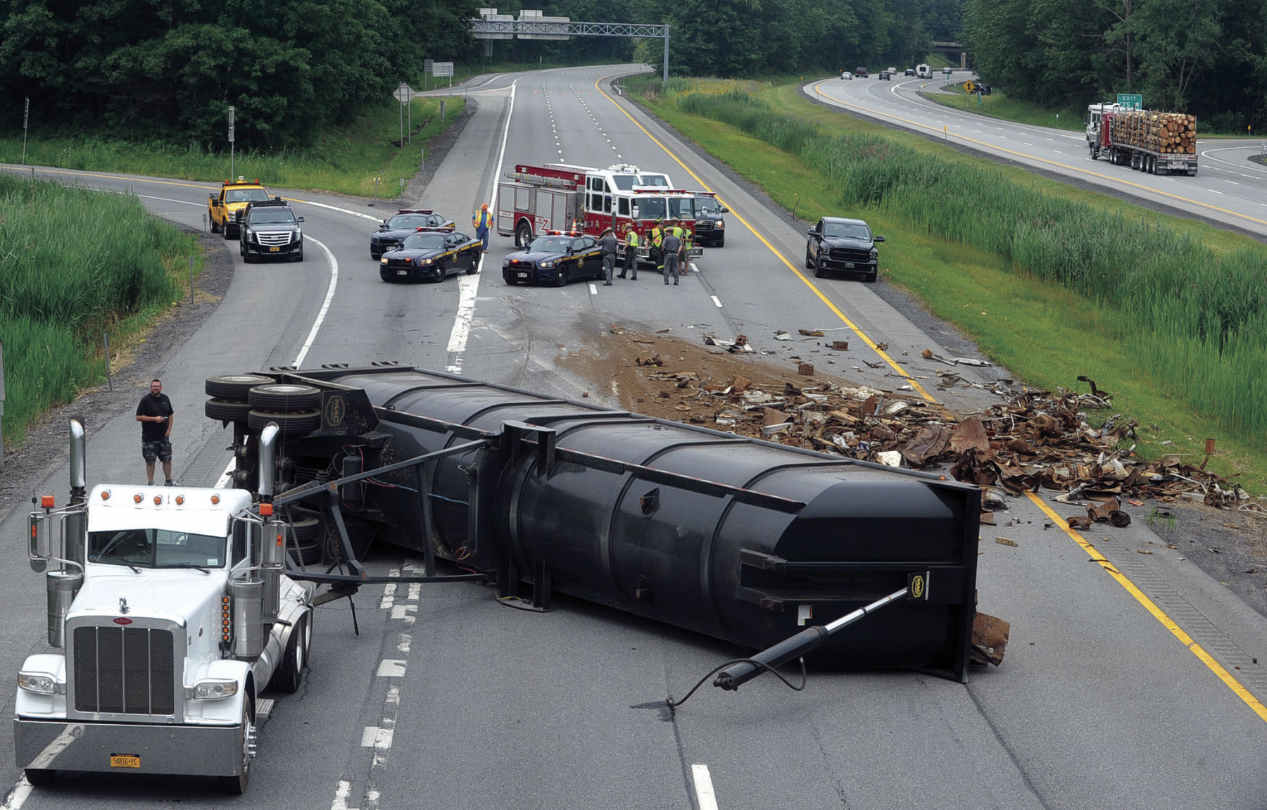 Tractor-trailer rolls over on Northway